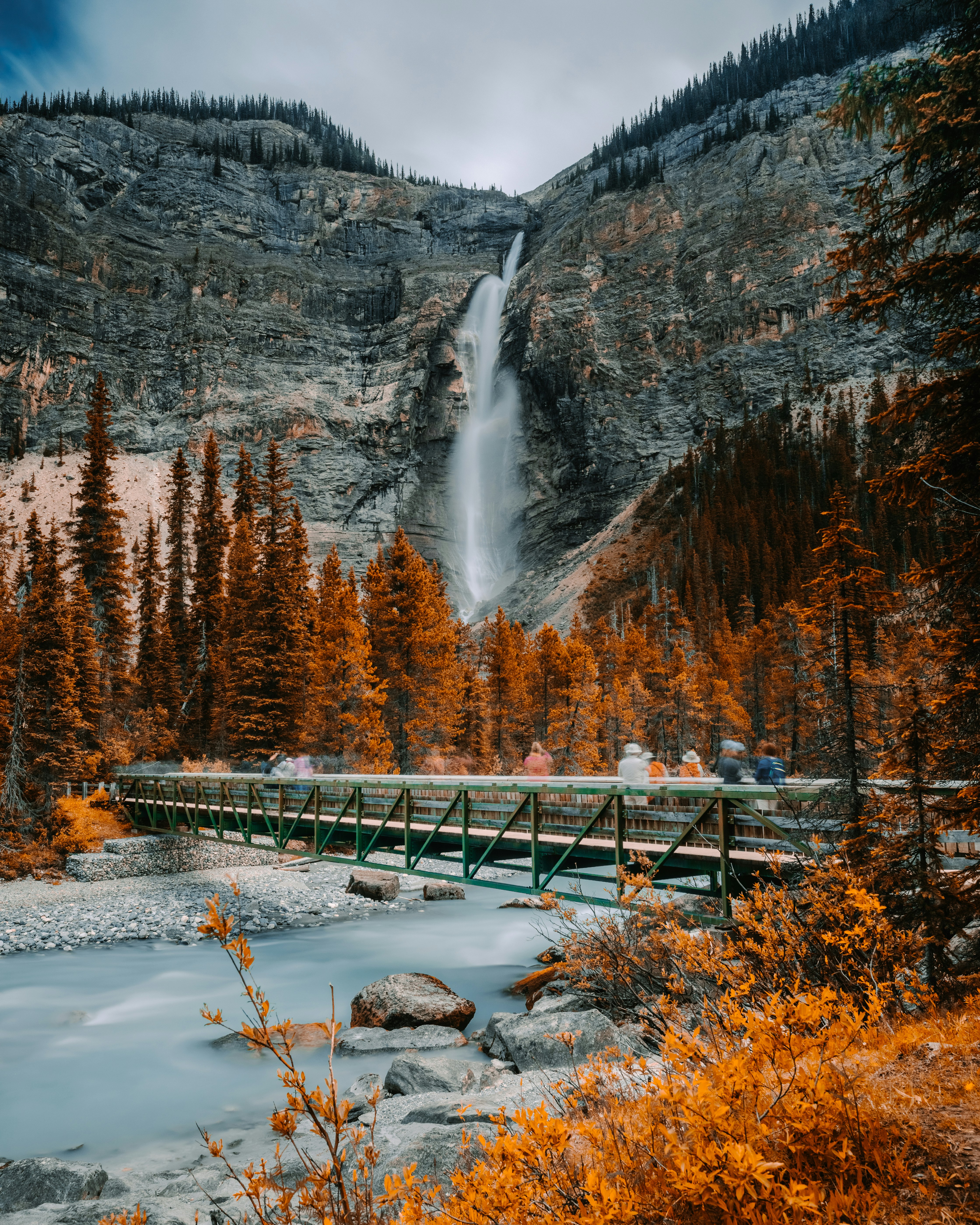 metal bridge near waterfall